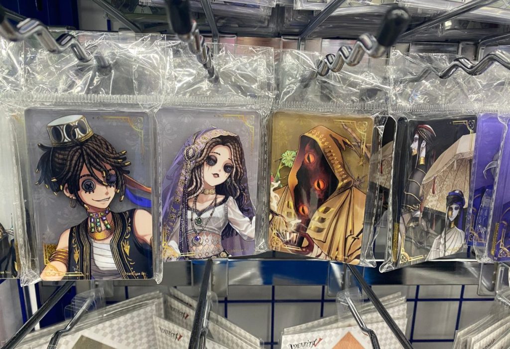 Four gothic character cards hanging in clear plastic packaging on display hooks.